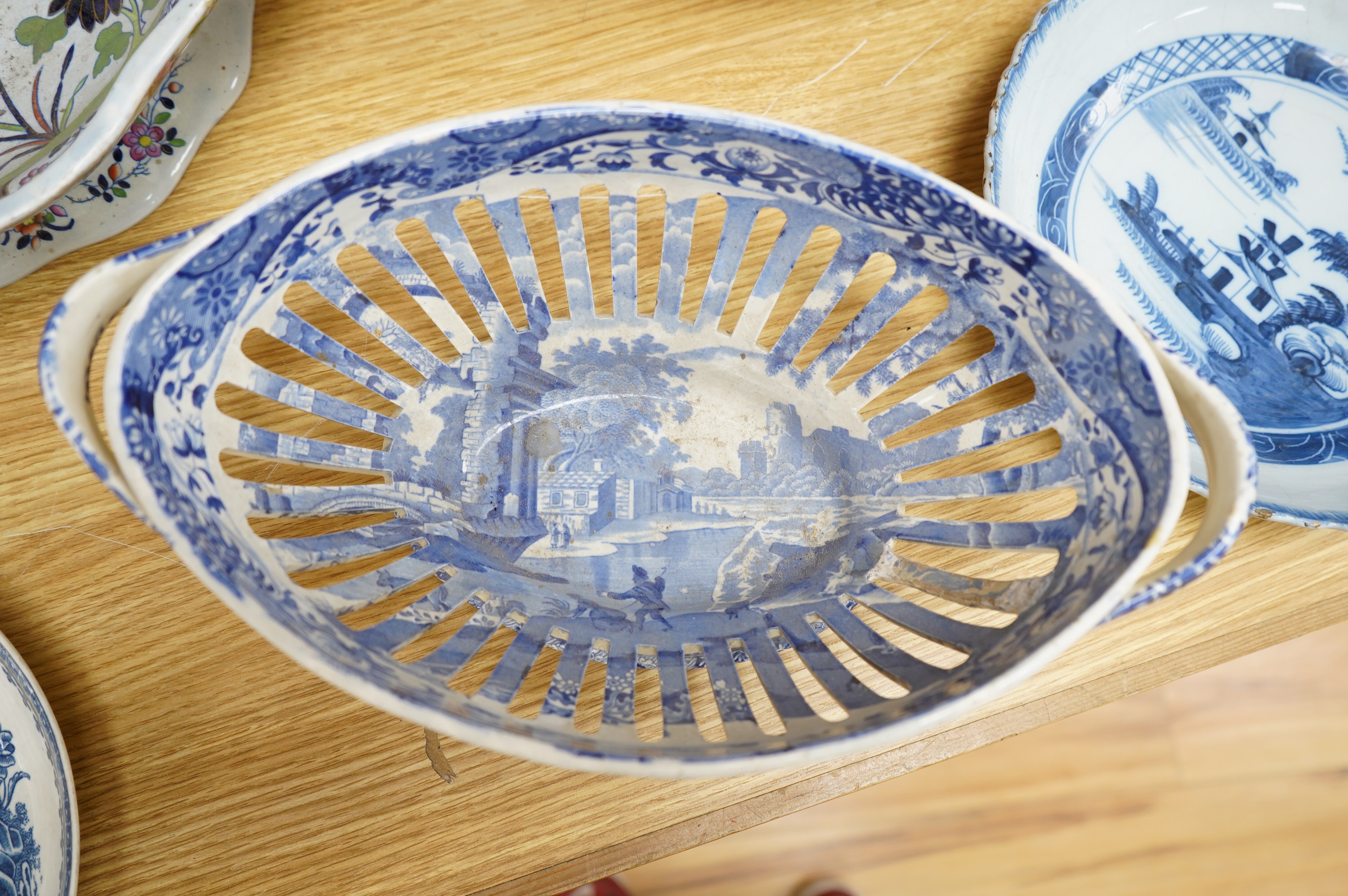 A Spode blue and white oval basket, a Spode two-handled pedestal dish, a Caughley Fisherman pattern saucer dish and two other items, largest 38cm wide. Condition - varies